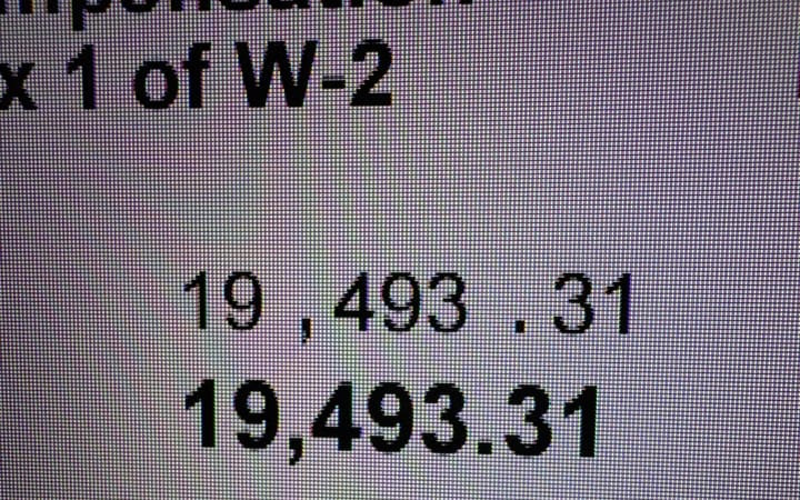 a photograph of a digital W2. The wage paid is USD 19,493.31. 